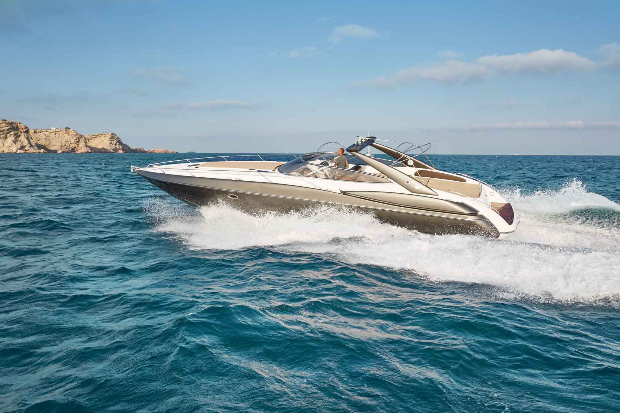 Our charter boat the Sunseeker Superhawk 48 cruising in bright blue water