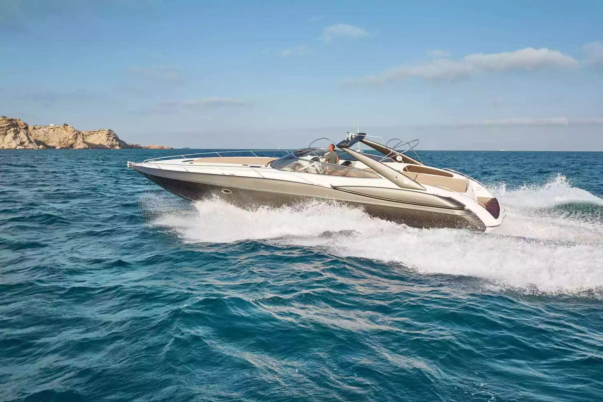Our charter boat the Sunseeker Superhawk 48 cruising in bright blue water